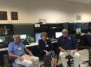 FEMA Administrator Craig Fugate, KK4INZ (right), dropped by WX4NHC at the National Hurricane Center (NHC) on October 1, as the station was activated for Hurricane Joaquin. He met with WX4NHC operator Hank Collins, W8KIW, and his wife Pat. [Julio Ripoll, WD4R, photo]